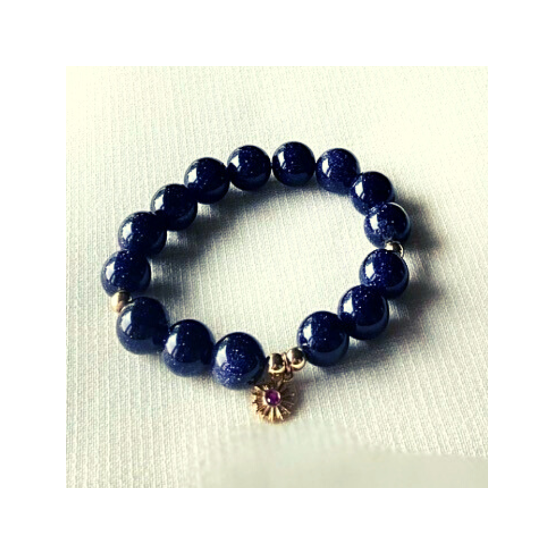 Blue sandstone bracelet with gold ruby charm