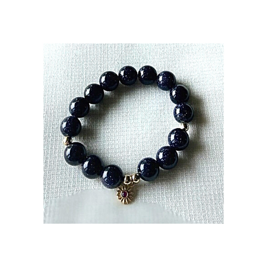 Blue sandstone bracelet with gold ruby charm